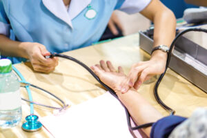 Image of the nurse's hand is measuring the pulse.